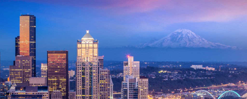 Photo of Seattle skyline and Mount Rainier at dusk