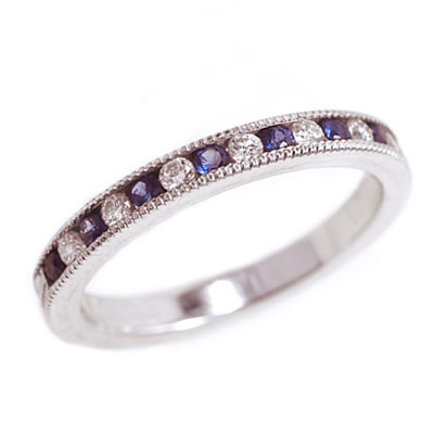 product shot of diamond and blue sapphire channel-set band in white metal