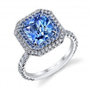 digital rendering of radiant cut blue sapphire ring with blue sapphire and diamond halos angled view