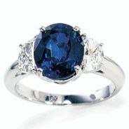 product image of blue sapphire three stone ring with side diamonds