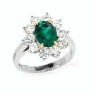 product image of oval emerald ring with round diamond halo in mixed-metals
