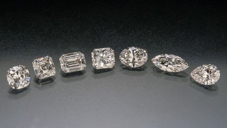 White diamonds of various shapes on dark grey background